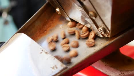 close-up of coffee beans being roasted in a machine