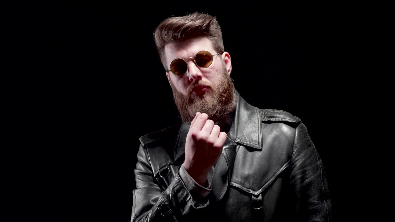 Man with beard and sunglasses in leather jacket