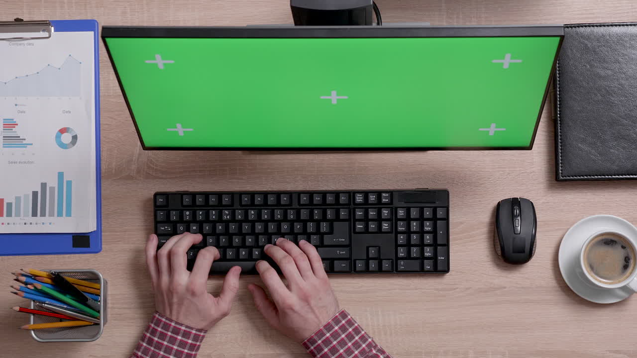 Typing on Keyboard at Office Desk with Green Screen Monitor
