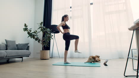 Eine-Junge-Frau-Macht-Yoga-Zu-Hause-Mit-Ihrem-Hund-Neben-Sich