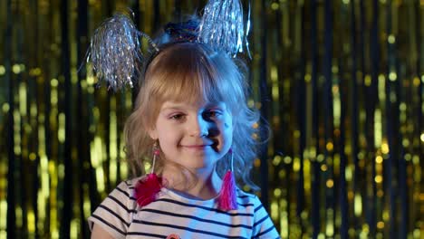 Portrait-of-trendy-stylish-girl-looking-at-camera,-smiling,-child-kid-in-neon-light-at-disco-club