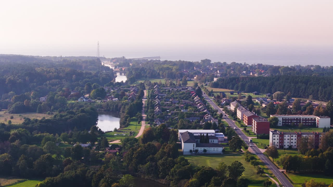 Drone shot of Pavilosta Latvia showing river, urban layout, and Baltic coastline.