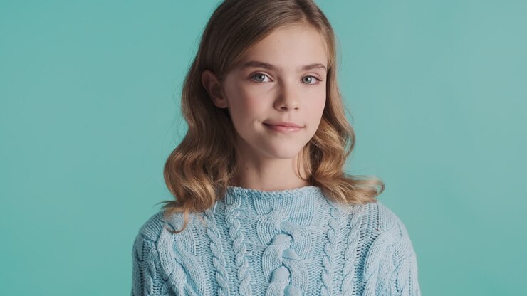 Happy teenage Caucasian girl winking in front of the camera.