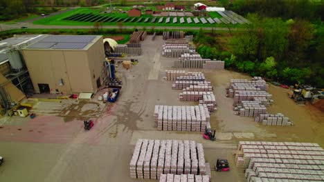 forklifts driving on yard looking to load trucks with freight