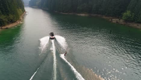 man wakeboarding with motorboat in the river 4k