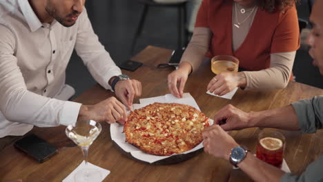 friends sharing pizza and drinks