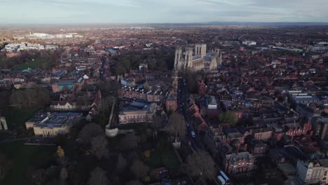 High-drone-shot-flying-backward-over-York-showing-York-Minster,-UK