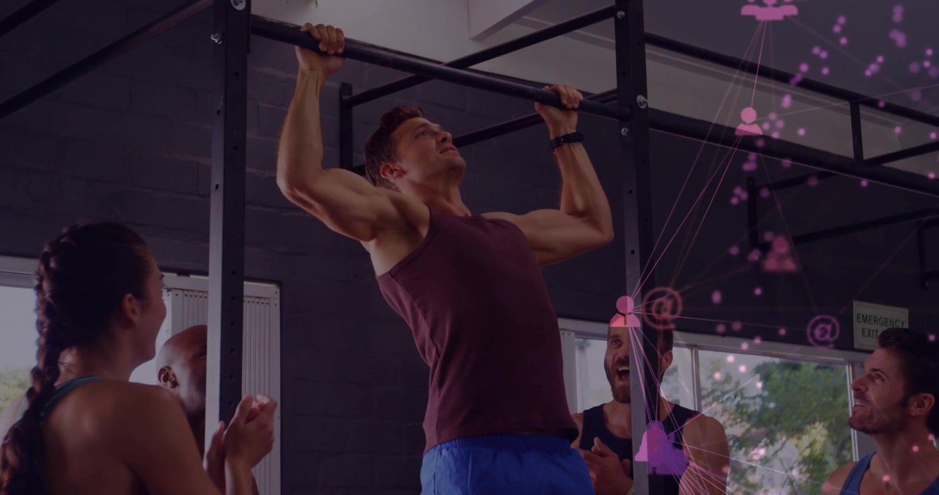 Man gripping bar and pulling up in gym, peers clapping while pink icons overlaying right