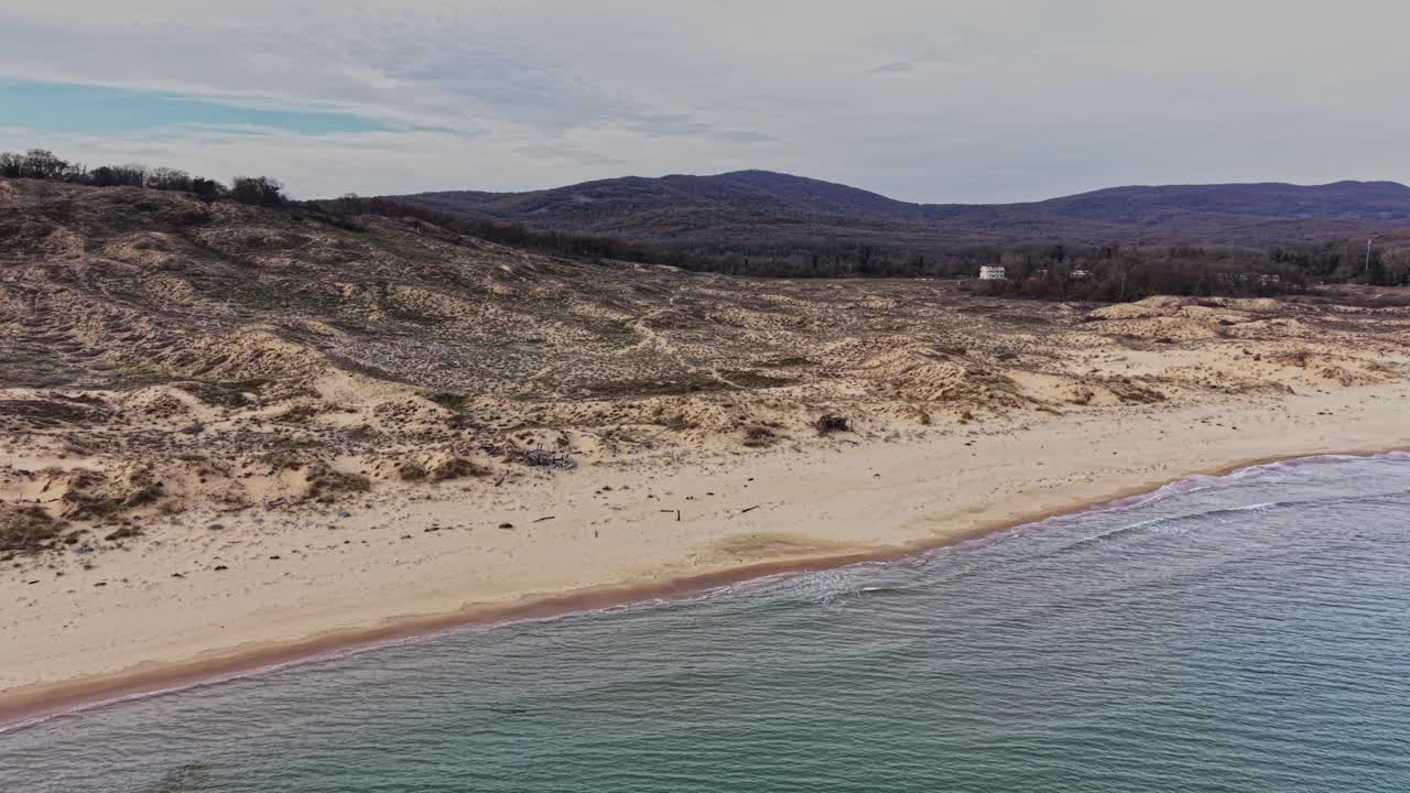 Scenic aerial view of a tranquil beach and rolling hills near the coast