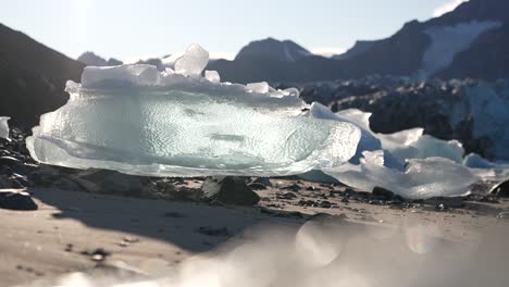 glacier ice melting on beach, fortende julibreen glacier, svalbard, norway