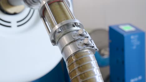 a tube carrying crushed olives through a small family run organic extra virgin olive oil production facility located in the region of abruzzo, italy that has been freshly harvested