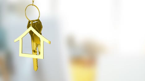 animation of gold house key fob and key dangling over out of focus interiors with copy space