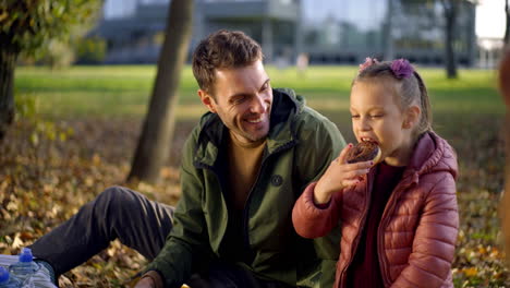 family enjoys picnic in the park