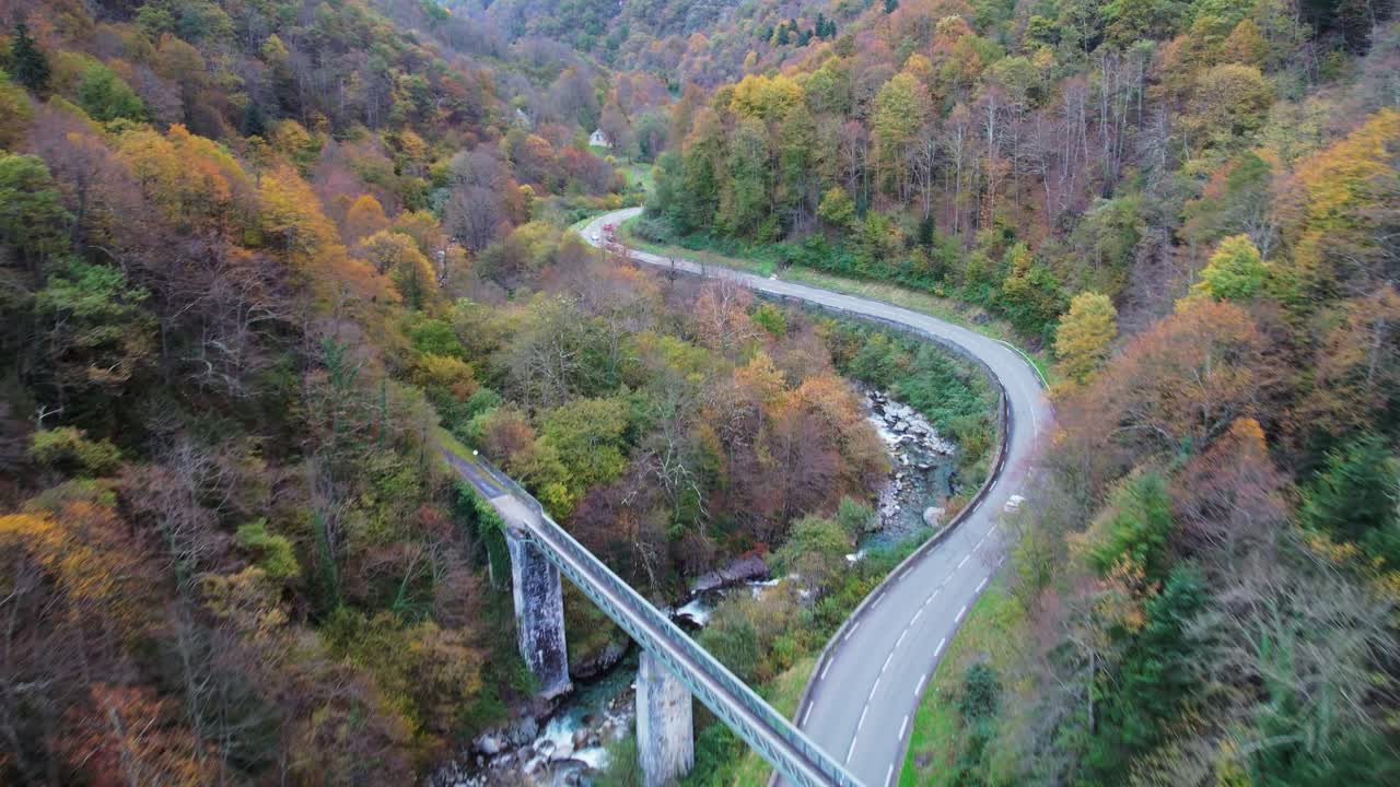 Mountain road with autumn trees in Pyrenees, leading to Cauterets