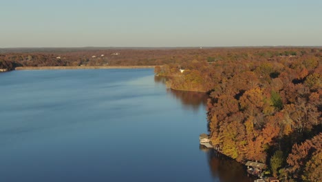 Aerial-view-of-Ozark-mountain-fall-colors-beside-lake