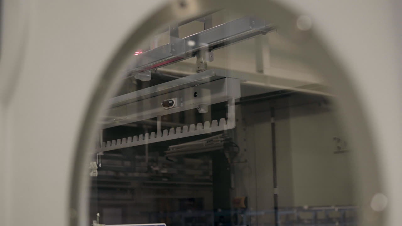 Close-up footage of an industrial conveyor system inside a modern factory. The moving production line highlights automated material handling and continuous workflow