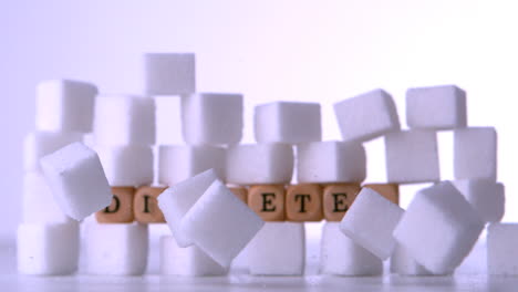pared de cubos de azúcar con dados que deletrean la diabetes
