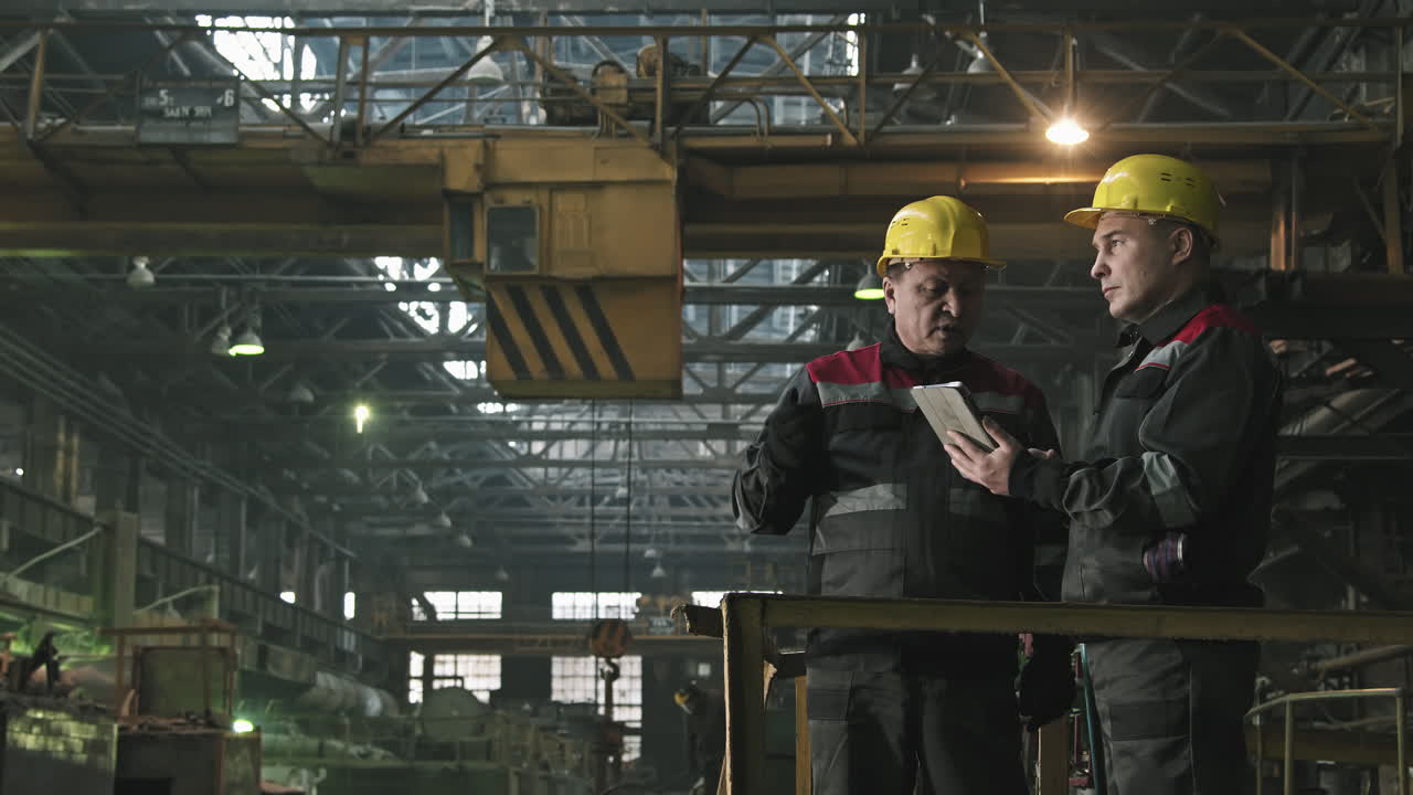 Tractor Plant Workers Having Conversation