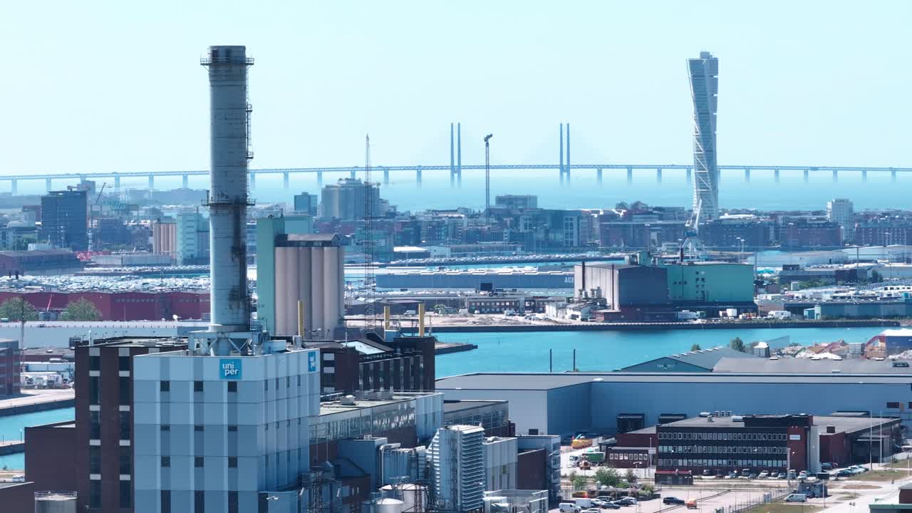 Industrial area in Malm&ouml; with &Ouml;resundsbron bridge in the background, aerial