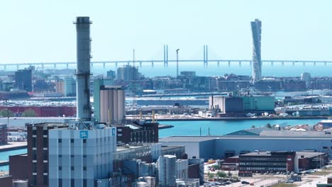 industrial area in malmö with öresundsbron bridge in the background, aerial