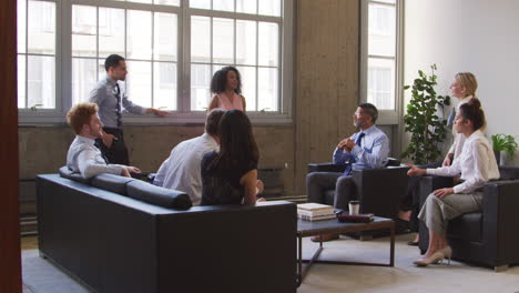 Black-businesswoman-addressing-colleagues-at-casual-meeting