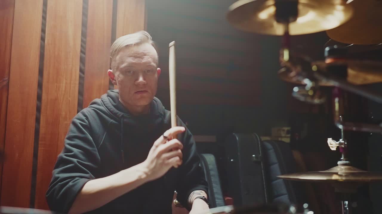 Drummer playing drums in a studio