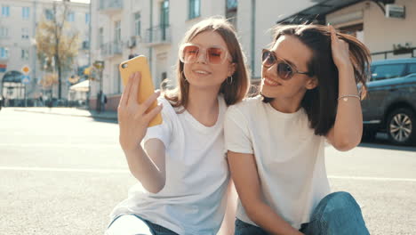 two girls taking a selfie in the city