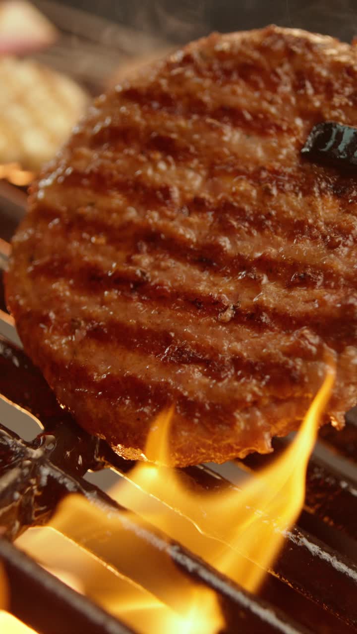 Burgers grilling with flames