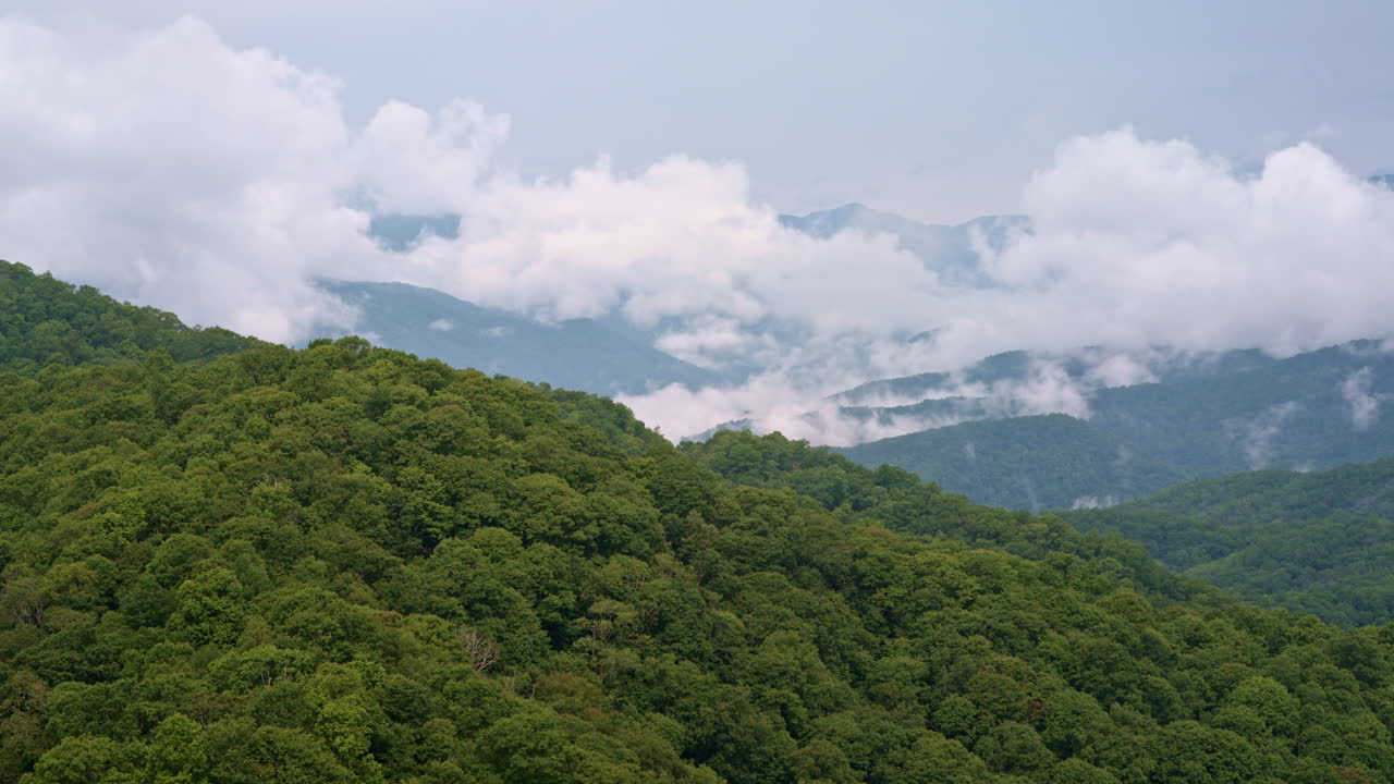Aerial cinematic view of the fog-shrouded Smoky Mountains