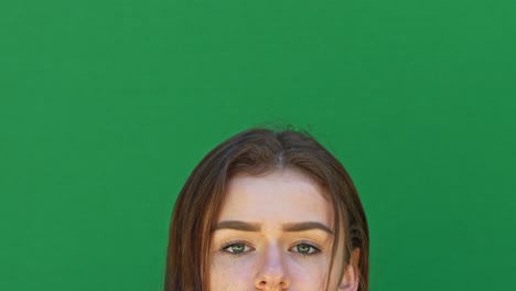 happy brunette adult girl looking up to empty green copy space