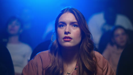 beautiful woman watching interesting film in movie theater