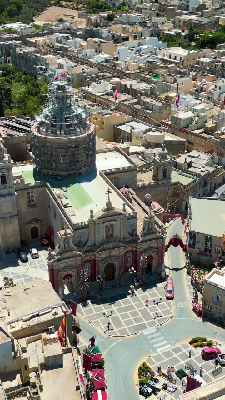 Aerial drone view of the walled city of Valletta, Malta, surrounded by the Mediterranean sea in daylight. Vertical vertical
