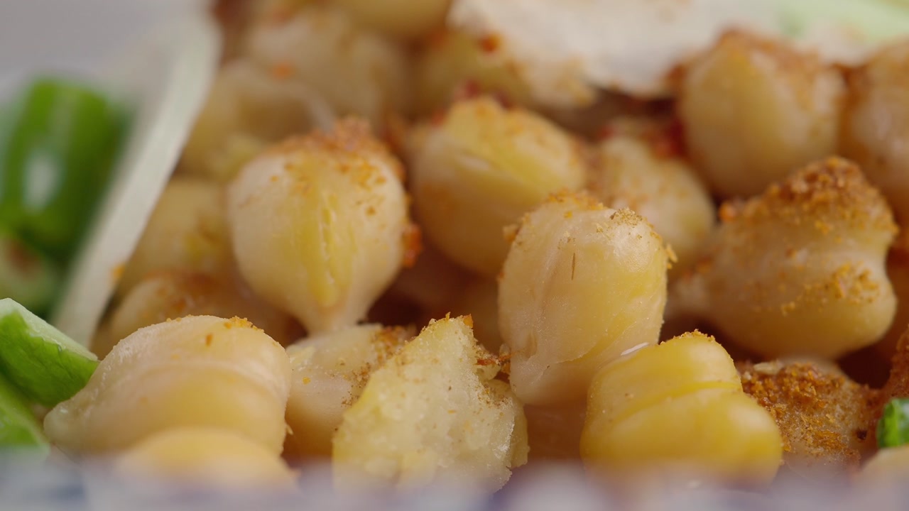 Close-up of Seasoned Chickpeas with Spices and Fresh Vegetables