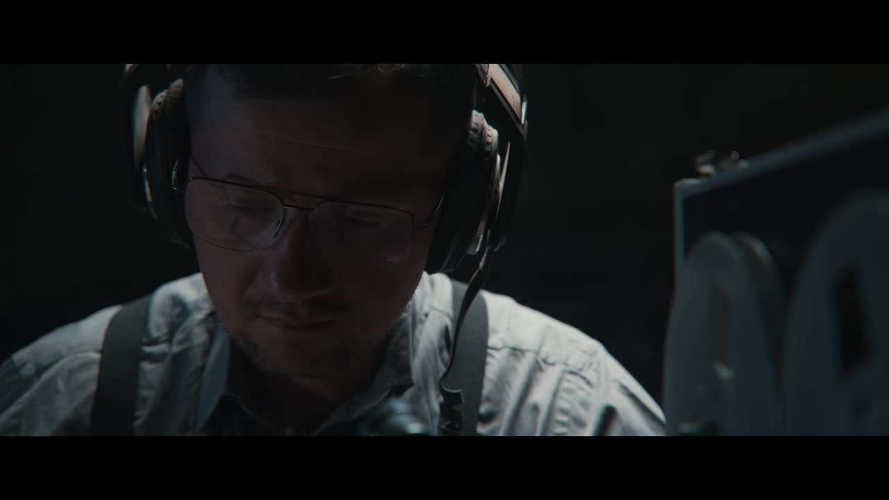 An intelligence officer listens to the wiretap recordings