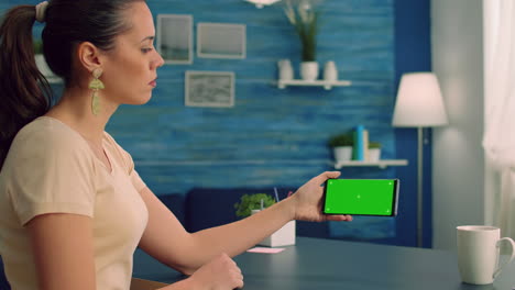 Social-media-person-holding-phone-with-mock-up-green-screen