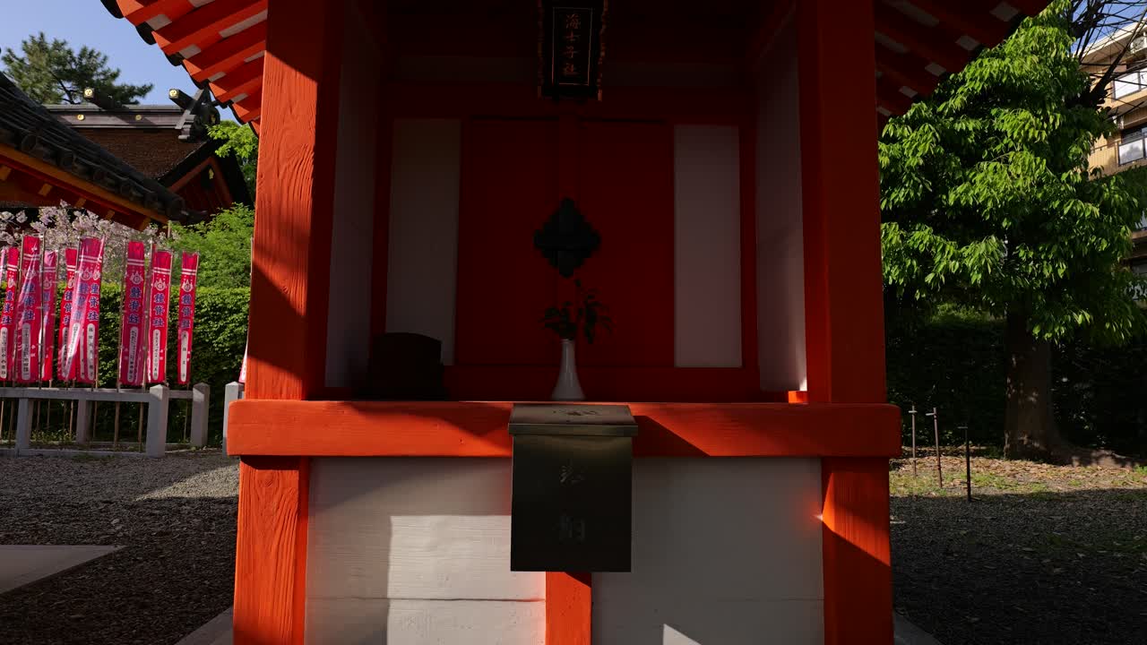 Capturing the bright orange architecture of an auxiliary shrine at the historic Sumiyoshi Taisha sanctuary in Osaka, Japan, Asia, on a clear sunny day
