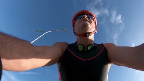 Low-angle-view-looking-up-at-a-man-riding-a-bike-from-a-camera-mounted-to-the-front-of-bicycle