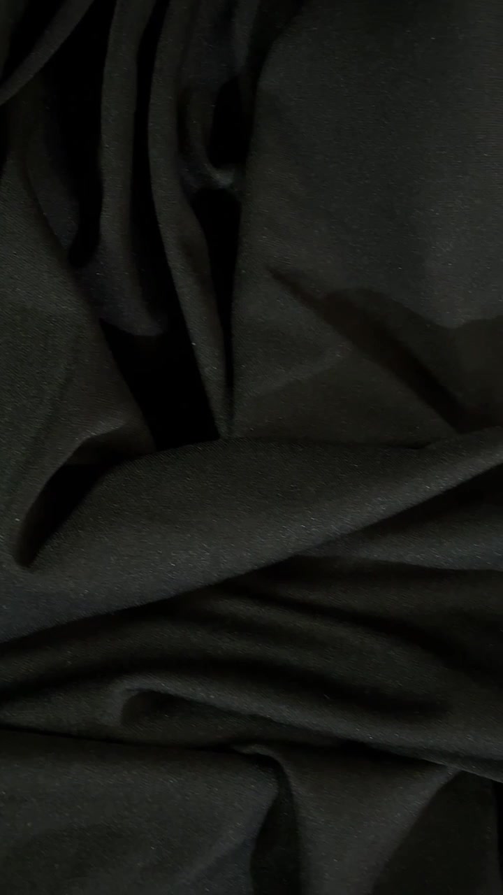 Black fabric texture with folds