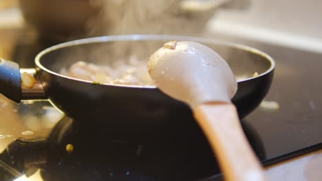 close-up of a pan with food cooking on a stovetop