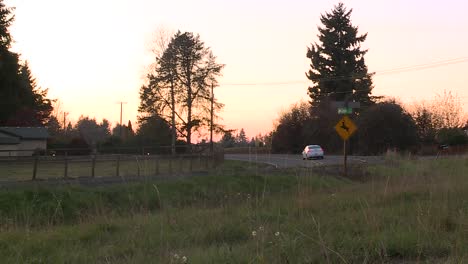 CAR-DRIVING-ON-CURVED-ROAD-AT-SUNSET