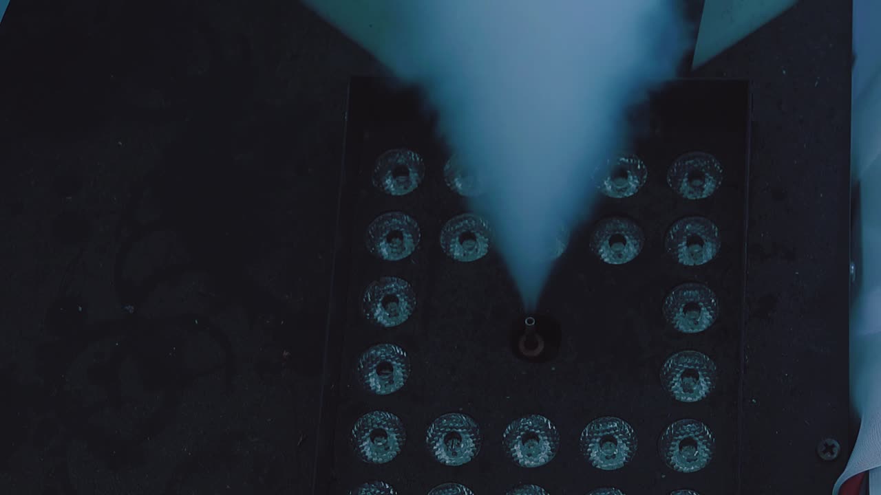 smoke bomb works in a disco the smoke is highlighted by a different light a close-up slow motion