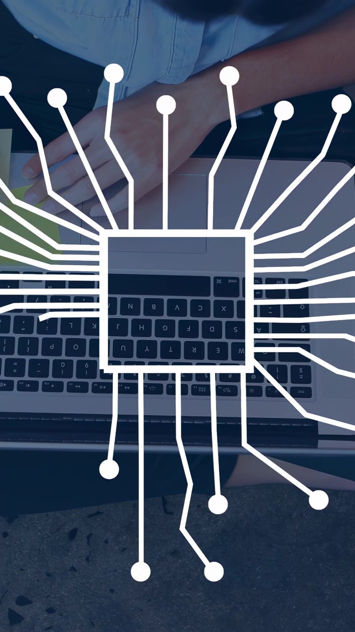 Vertical video: Woman placing note, typing, causing circuit to grow into chip over keys for tech