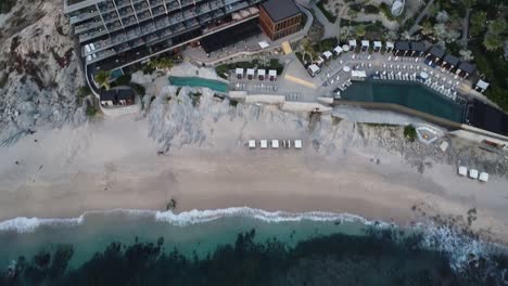 aerial view from a luxury hotel overlooking the multi-story building, swimming pools and vacationers at the cape thompson hotel in los cabos on monument beach during a mexico vacation