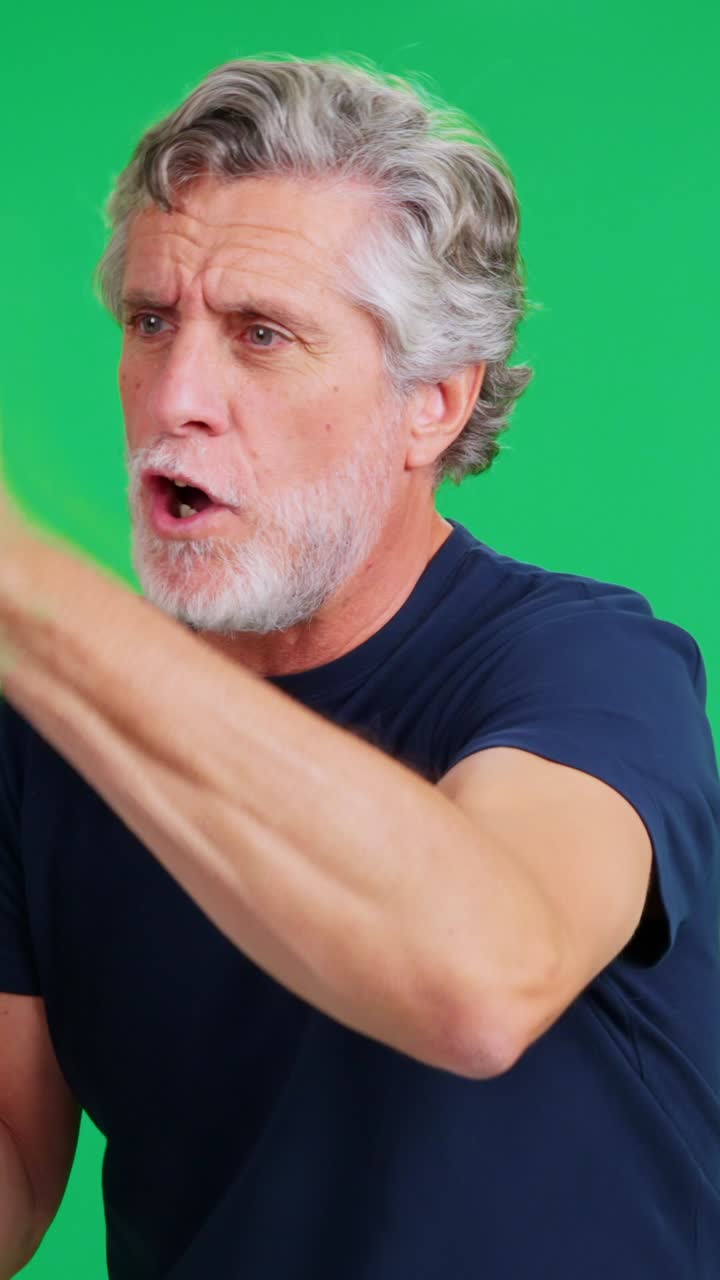 Mature Man Shouting into a Megaphone on Green Screen