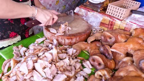 vendor chopping meat at a bustling market