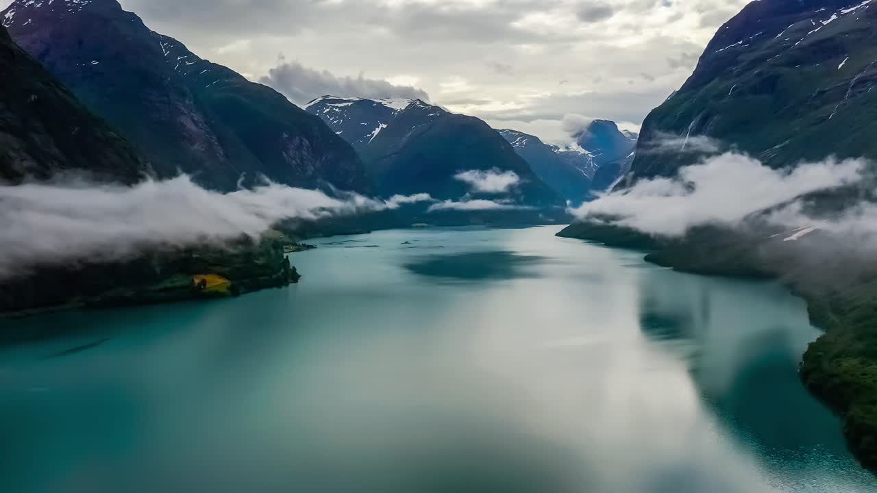 Beautiful Nature Norway natural landscape lovatnet lake flying over the clouds.