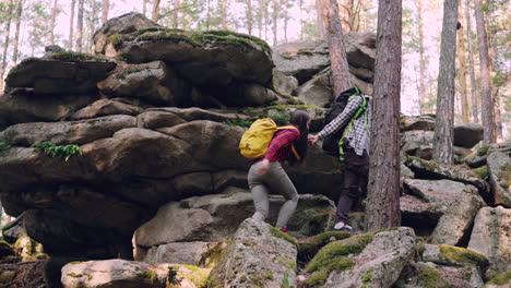 couple hiking through rocky forest