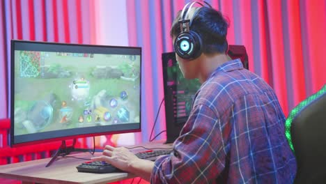 Young Asian Man Gamer Playing Online Video Game