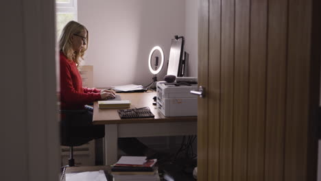 woman working at a desk in her home office