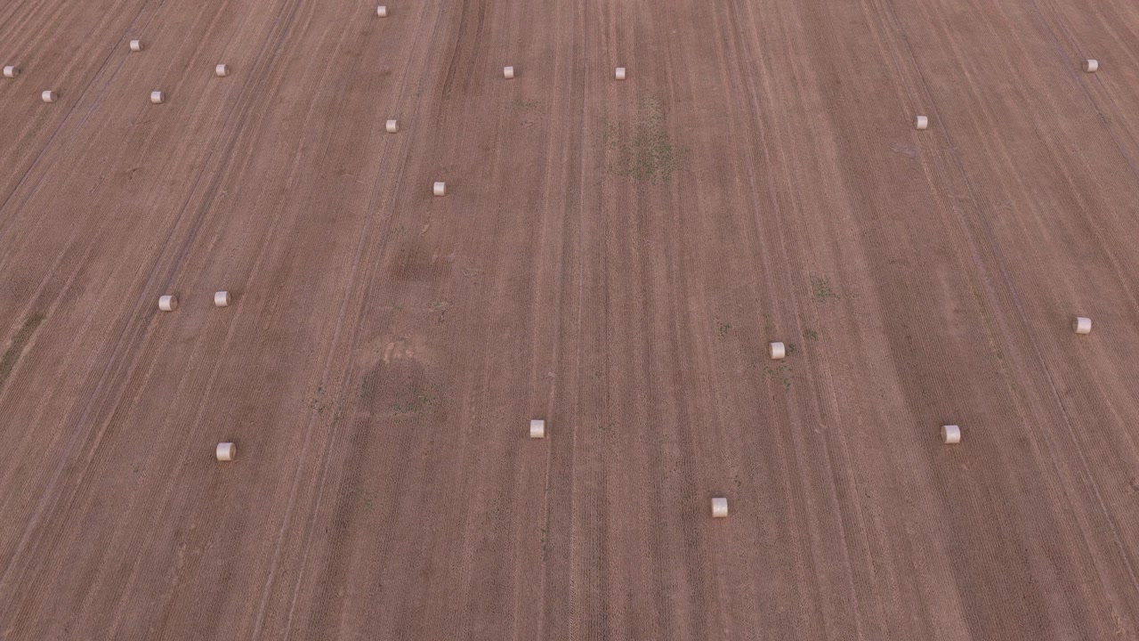 Aerial view of hay bales on a harvested field. Farming in the Czech Republic in summer. Drone view